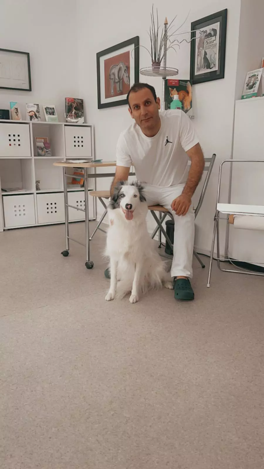 Dr. Emad Merey und ein Hund blicken freundlich in die Kamera
